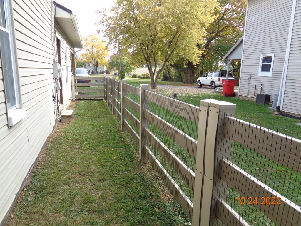 This is a tan vinyl PVC board fence